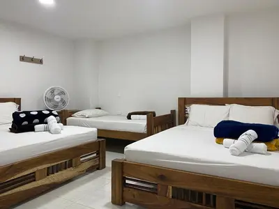 a room with two beds and a fan at HOTEL LA SELVA JARDIN in Jardin