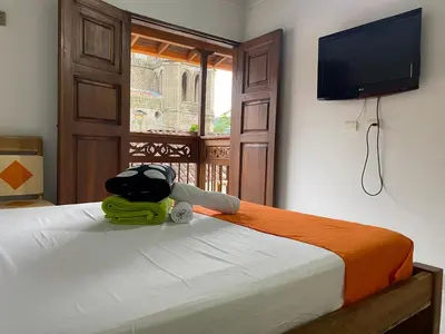 a stuffed animal sitting on a bed in a room at HOTEL LA SELVA JARDIN in Jardin