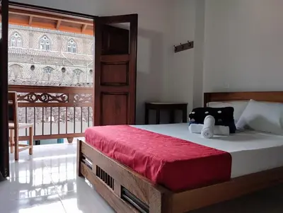 a bedroom with a bed with a teddy bear on it at HOTEL LA SELVA JARDIN in Jardin