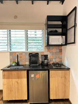 a kitchen with a counter top and a microwave at Studio in Poblado near Envigado FRN103 By Roots Rentals in Medellín
