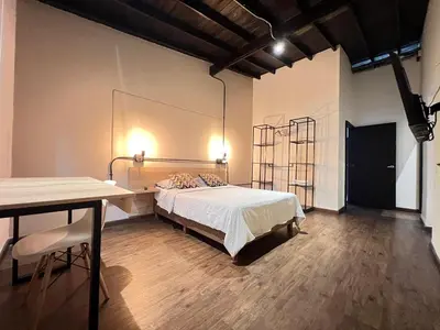 a bedroom with a bed and a table in it at Studio in Poblado near Envigado FRN103 By Roots Rentals in Medellín