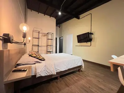 a room with a bed and a television in it at Studio in Poblado near Envigado FRN103 By Roots Rentals in Medellín
