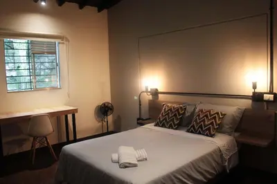 a bedroom with a bed with two towels on it at Studio in Poblado near Envigado FRN103 By Roots Rentals in Medellín