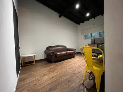 a living room with a couch and a yellow chair at Studio in Poblado near Envigado FRN103 By Roots Rentals in Medellín