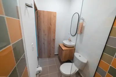 a small bathroom with a toilet and a sink at Loft equipado en Poblado cerca de Envigado FRN107 By Roots Rentals in Medellín