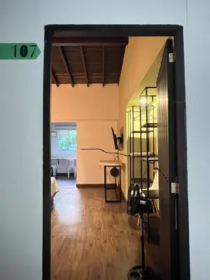 an open door to a living room with a desk at Loft equipado en Poblado cerca de Envigado FRN107 By Roots Rentals in Medellín