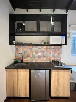 a kitchen with a sink and a stove at Loft equipado en Poblado cerca de Envigado FRN107 By Roots Rentals in Medellín
