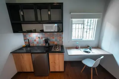 a small kitchen with a sink and a stove at Loft equipado en Poblado cerca de Envigado FRN107 By Roots Rentals in Medellín