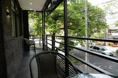 a balcony with a table and chairs looking out at a street at Hotel Nakama in Medellín