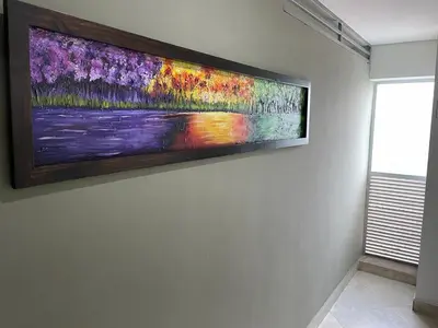 a painting hanging on a wall in a room at Apartamento Amoblado laureles estadio in Medellín