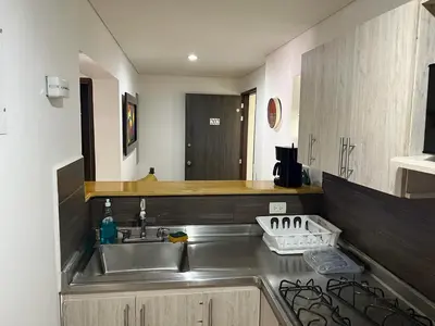 a kitchen with a sink and a counter top at Apartamento Amoblado laureles estadio in Medellín