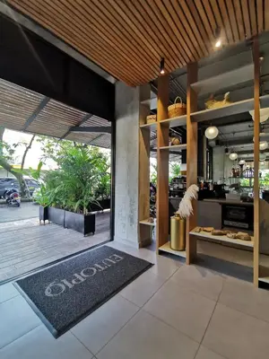 an open kitchen with a large glass door and a rug at Eutopiq Hotel in Medellín