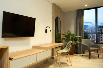 a living room with a flat screen tv on a wall at Eutopiq Hotel in Medellín