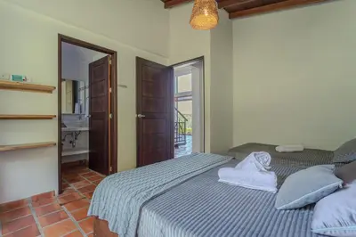 a bedroom with a bed with towels on it at La Villa, Espectaculares vistas al lago Peñol-Guatape in Guatapé