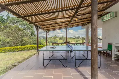 a picnic table under a pergola on a patio at La Villa, Espectaculares vistas al lago Peñol-Guatape in Guatapé