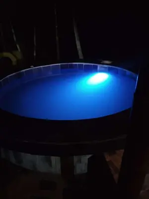 a blue tub with a light in the dark at Finca Hotel Alto la María in Angelópolis