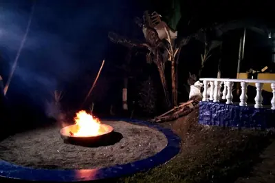 a fire pit in the yard at night at Finca Hotel Alto la María in Angelópolis