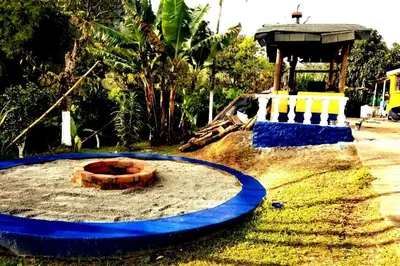 a playground with a blue circle in the sand at Finca Hotel Alto la María in Angelópolis