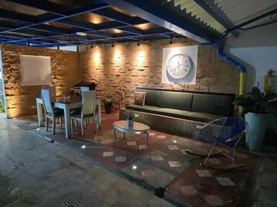a living room with a couch and a table and chairs at Casa Hotel Victoria Real in Mariquita