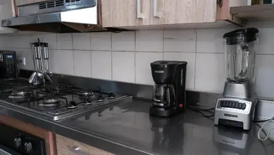a kitchen counter with a blender on a stove at Casa La Palma Habitación Cielo in Medellín