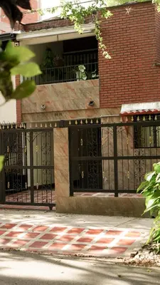 a building with a black fence in front of a building at Casa La Palma Habitación Cielo in Medellín