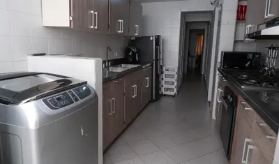 a kitchen with a dishwasher and a washer in it at Casa La Palma Habitación Cielo in Medellín