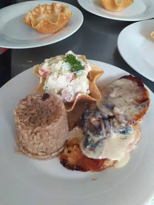 a white plate with food on a table at El Edén hotel Campestre in Pensilvania