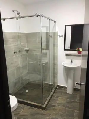a bathroom with a shower and a toilet and a sink at El Edén hotel Campestre in Pensilvania