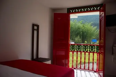 a room with a red door and a balcony at El Edén hotel Campestre in Pensilvania