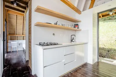 a kitchen with white cabinets and a counter top at KABINE in El Peñol