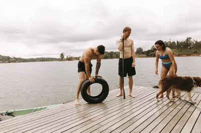 a group of people standing on a dock with a tire at KABINE in El Peñol