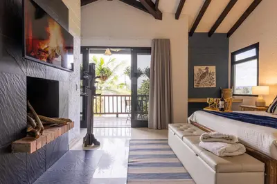 a bedroom with a fireplace and a bed in a room at KABINE in El Peñol