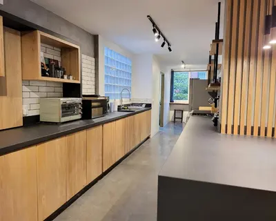a kitchen with wooden cabinets and a counter top at Center City Flats - Apartments in El Poblado near Park Lleras, Medellin! in Medellín