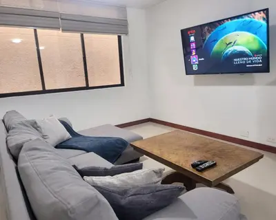 a living room with a couch and a table at Center City Flats - Apartments in El Poblado near Park Lleras, Medellin! in Medellín