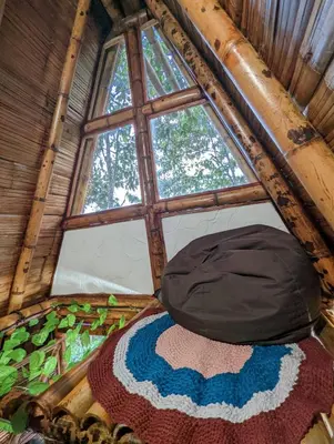 a large window in a room with a bed at Cabañas Camino al Agua - Cocorná in Cocorná