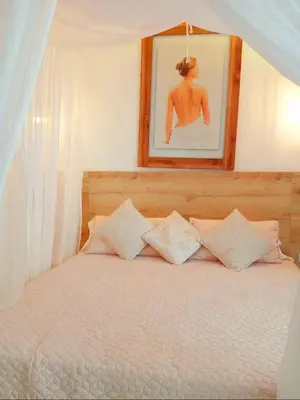 a bedroom with a bed with a picture on the wall at Hotel Monte Bello in Doradal