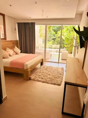 a bedroom with a bed and a large window at Hotel Monte Bello in Doradal