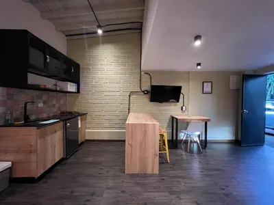 a room with a kitchen with a table and a counter at FRN101 Cozy loft located in a popular in Poblado By Roots Rentals in Medellín