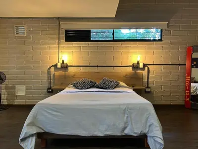 a bedroom with a bed with two pillows on it at FRN101 Cozy loft located in a popular in Poblado By Roots Rentals in Medellín
