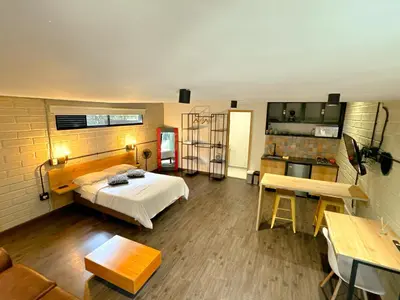 a large room with a bed and a kitchen at FRN101 Cozy loft located in a popular in Poblado By Roots Rentals in Medellín