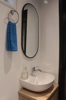a bathroom with a white sink and a mirror at Apartamento en el Poblado, permite mascota FRN102 By Roots Rentals in Medellín