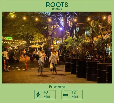 a group of people walking down a street at night at Apartamento en el Poblado, permite mascota FRN102 By Roots Rentals in Medellín