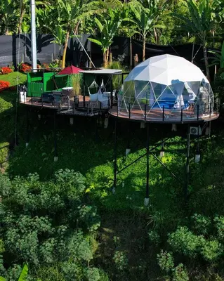 a pavilion with a tent and chairs in a park at Chamí Glamping in Manizales
