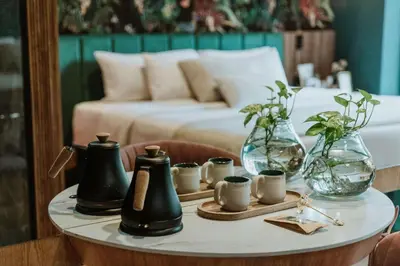 a table with jars and vases on top of a bed at Selvario 36 Hotel in Medellín