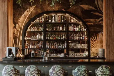 a bar with a lot of bottles of alcohol at Selvario 36 Hotel in Medellín