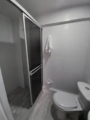 a bathroom with a shower and a toilet and a sink at Apartaestudio1 Amoblado sector Cable Estadio in Manizales