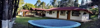 a house with a blue pool in the yard at finca Encanto in Guarne