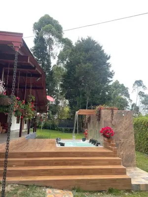 a patio with a pool and stairs next to a house at finca Encanto in Guarne