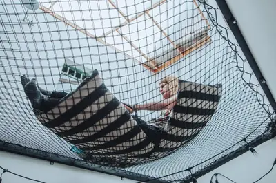 a person sitting in a hammock in a cage at Centro Hostel Medellin in Medellín