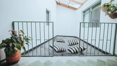 a cage with pillows on a balcony at Centro Hostel Medellin in Medellín